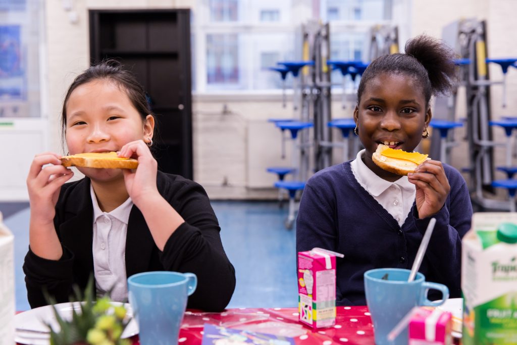 Isabella and Clarissa eat toast at Deptford Park School, 2016