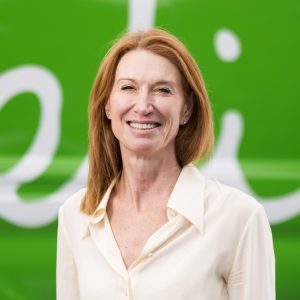 Headshot of Cath Thorpe smiling in front of Felix branded green van