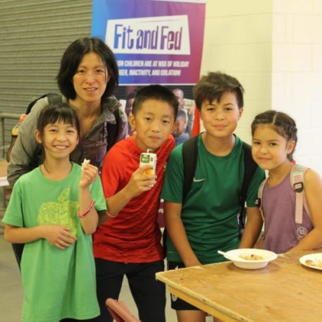 That’s a wrap! Children enjoy one of the healthy snacks prepared by volunteers.