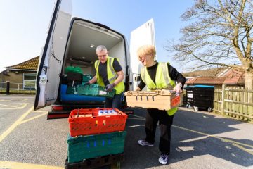 Woman And Man Unloading Food