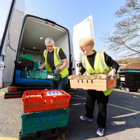 Woman And Man Unloading Food