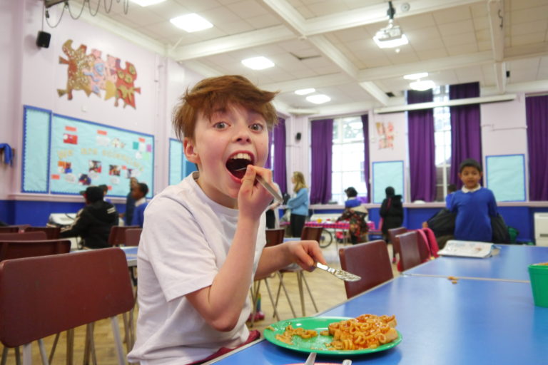 Andy eating beans at Millpond Primary Breakfast Club