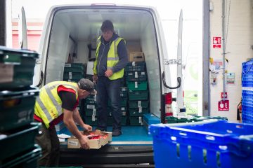 FareShare volunteers loading van with food