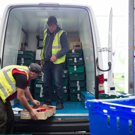 FareShare volunteers loading van with food