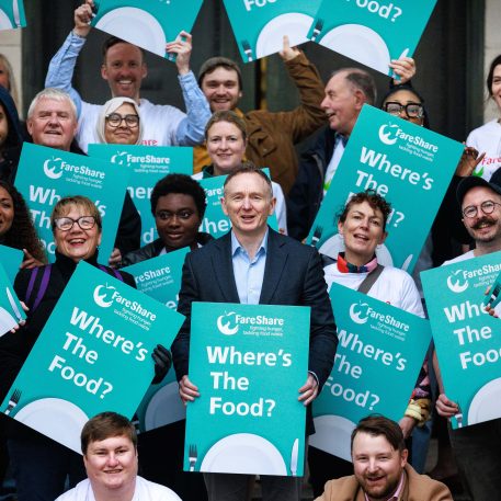 FareShare CEO George Wright stands with a group of charity leaders and volunteers holding placards saying "Where's The Food?", all protesting for Government support for food surplus redistribution.